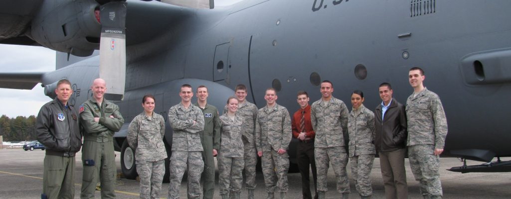 UConn cadets posing for a picture next to an Air Force airplane
